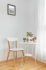 Image showing White interior with modern furniture and spring flowers