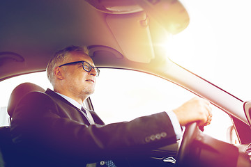 Image showing happy senior businessman driving car