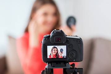 Image showing woman with eyebrow pencil recording video at home