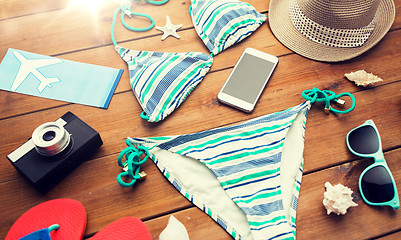 Image showing close up of smartphone and beach stuff