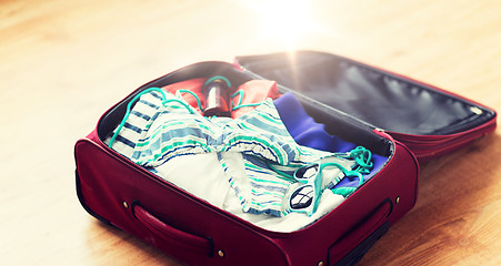 Image showing close up of travel bag with beach clothes