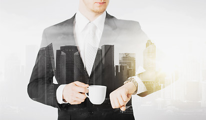 Image showing close up of businessman with wristwatch and coffee