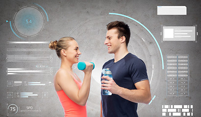 Image showing sportive man and woman with dumbbell and water