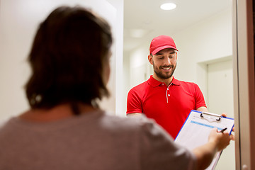 Image showing deliveryman with clipboard at customer home