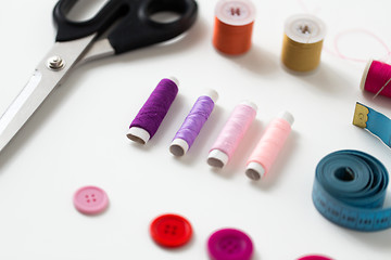 Image showing scissors, sewing buttons, threads and tape measure