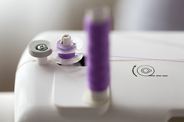 Image showing thread spools on sewing machine