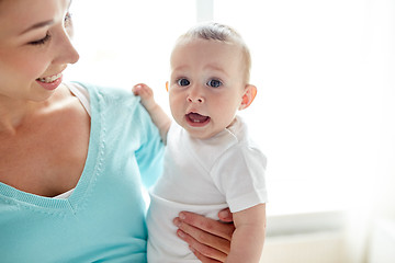 Image showing happy young mother with little baby at home