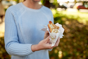 Image showing close up of woman with hot dog