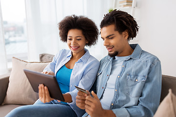 Image showing couple with tablet pc and credit card at home