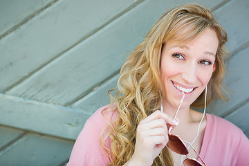 Image showing Outdoor Portrait of Young Adult Brown Eyed Woman With Sunglasses