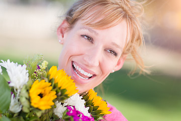 Image showing Outdoor Portrait of an Excited Young Adult Brown Eyed Woman Hold