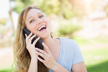 Image showing Young Adult Woman Outdoors Talking on Her Smart Phone.