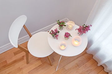 Image showing Cozy interior with candle lights and spring flowers