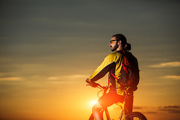 Image showing Sporty Man Riding a Bicycle on the Country Road.