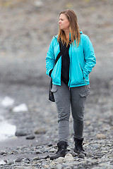 Image showing Woman walking over the beach at Jokulsarlon glacier lagoon - Ice