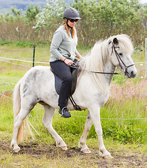 Image showing Woman riding a horse