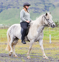 Image showing Woman riding a horse