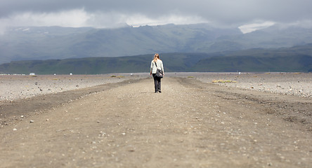 Image showing Woman hiker walking in mountain landscape