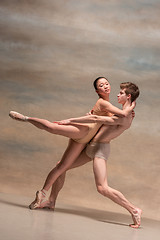 Image showing Couple of ballet dancers posing over gray background