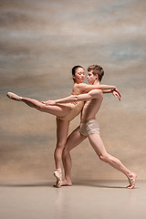 Image showing Couple of ballet dancers posing over gray background