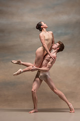 Image showing Couple of ballet dancers posing over gray background