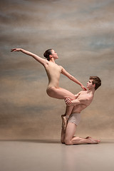 Image showing Couple of ballet dancers posing over gray background