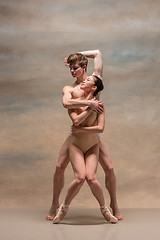 Image showing Couple of ballet dancers posing over gray background