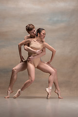 Image showing Couple of ballet dancers posing over gray background