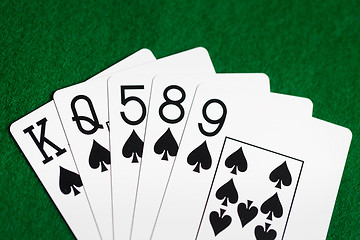 Image showing poker hand of playing cards on green casino cloth