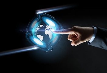 Image showing hand pointing finger to virtual earth projection