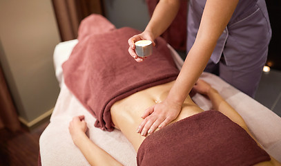 Image showing woman lying and having massage with hot oil at spa