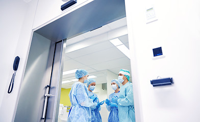 Image showing group of surgeons in operating room at hospital