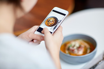 Image showing woman with smartphone photographing food at cafe