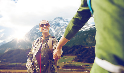 Image showing happy couple with backpacks hiking outdoors