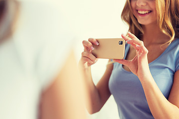 Image showing close up of teen girl taking picture by smartphone