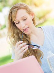 Image showing Young Adult Woman With Glasses Outdoors Using Her Laptop.