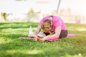 Image showing Young Fit Flexible Adult Woman Outdoors on The Grass With Yoga M