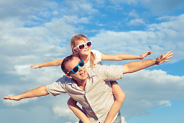 Image showing Father and daughter playing in the park  at the day time.