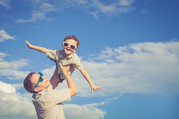 Image showing Father and son playing in the park  at the day time.