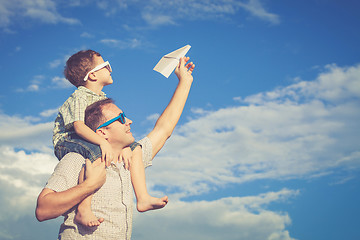 Image showing Father and son playing in the park  at the day time.