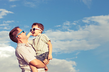 Image showing Father and son playing in the park  at the day time.