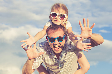 Image showing Father and daughter playing in the park  at the day time.