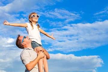 Image showing Father and daughter playing in the park  at the day time.