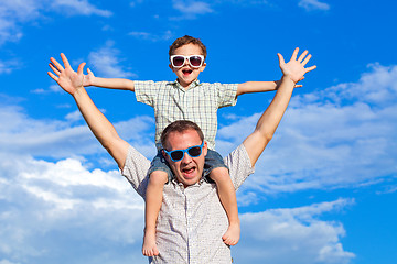 Image showing Father and son playing in the park  at the day time.