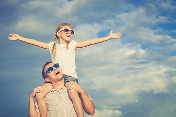 Image showing Father and daughter playing in the park  at the day time.