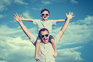 Image showing Father and son playing in the park  at the day time.