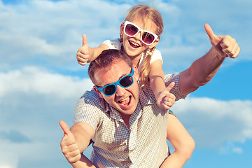 Image showing Father and daughter playing in the park  at the day time.