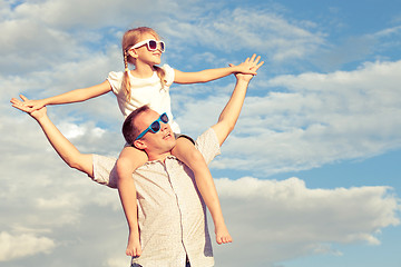 Image showing Father and daughter playing in the park  at the day time.