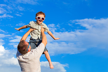 Image showing Father and son playing in the park  at the day time.