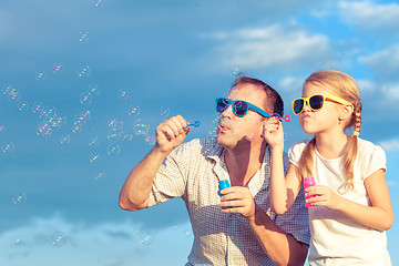 Image showing Father and daughter playing in the park  at the day time.